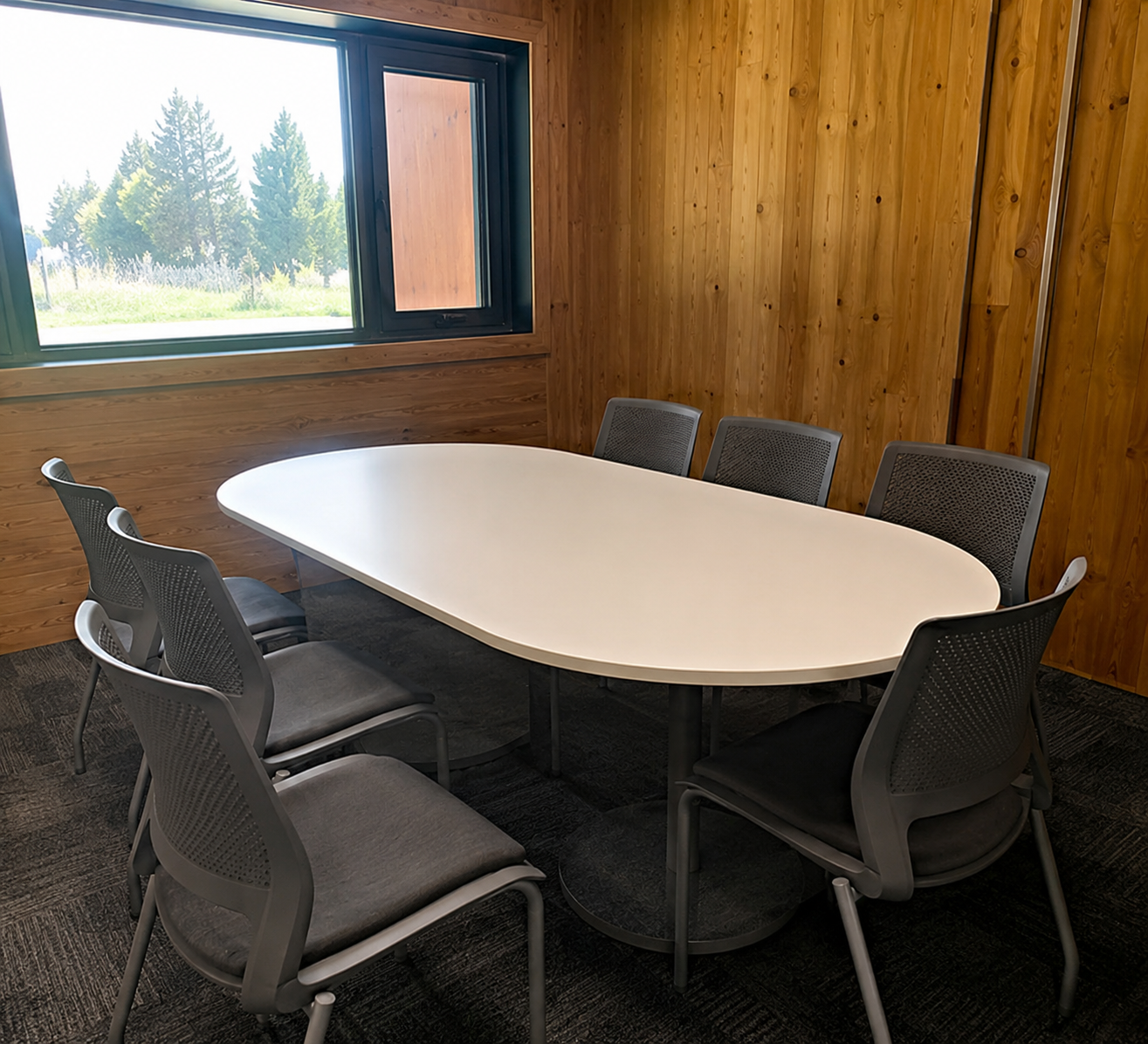 The Castlegar Sunrise Rotary Meeting Room with an oval table and window view